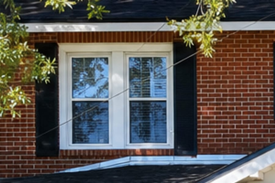 Detail crop of a shuttered second-floor window from the standard resolution download, enlarged to print size. Leaves and brick lose their edges.